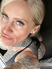 Mature tattooed bitch shows her boobs
